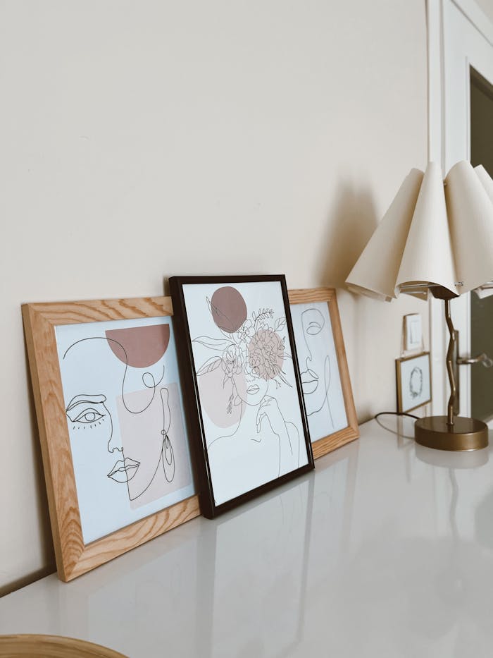 our-story Abstract art prints on a minimalistic desk setup with modern decor.